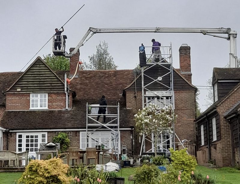 The Moss Cleaners using cherry picker and scaffolding to clean roof safely and professionally in London, 3 Sherwood Park Rd, Sutton SM1 2SQ, UK
